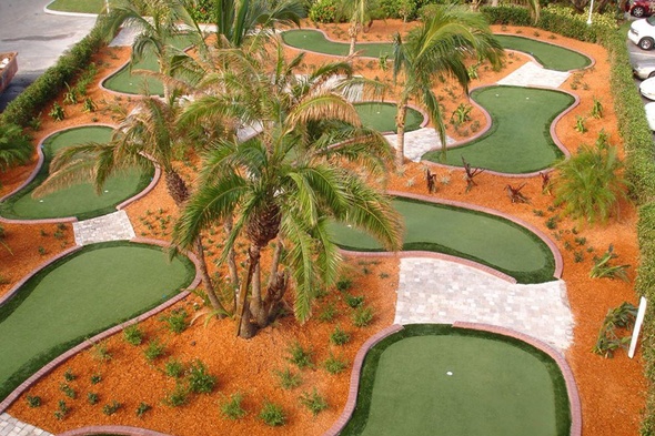 Toronto Aerial view of a mini golf course with synthetic grass and palm trees.